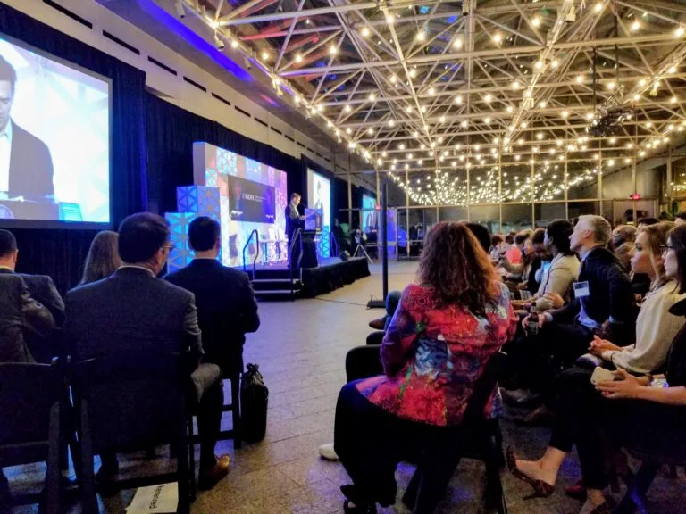Corporate holiday party planning in the DMV — a corporate event space set with blue lighting