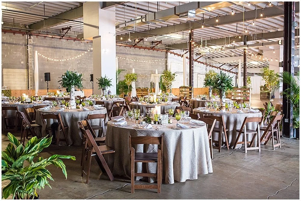 Warehouse reception with round tables and wood chairs