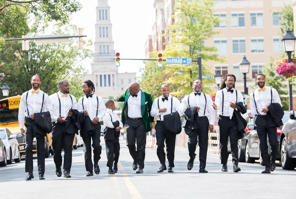 Groomsmen walking a city crosswalk