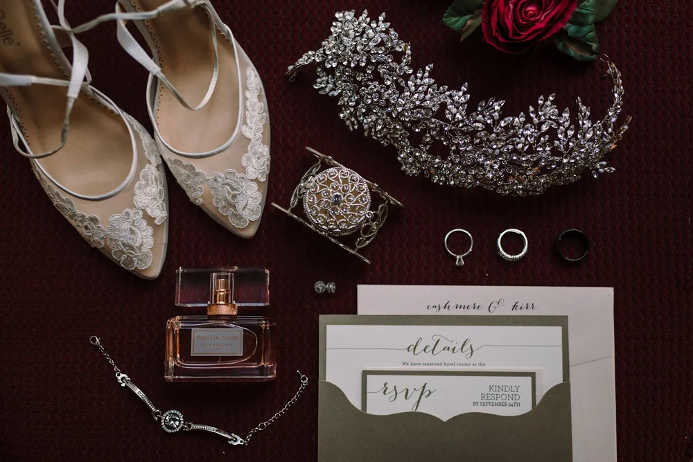 Bridal accessories flat lay on burgundy velvet