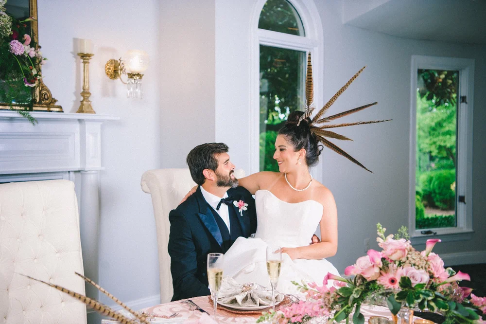 Couple toasting at a styled sweetheart table