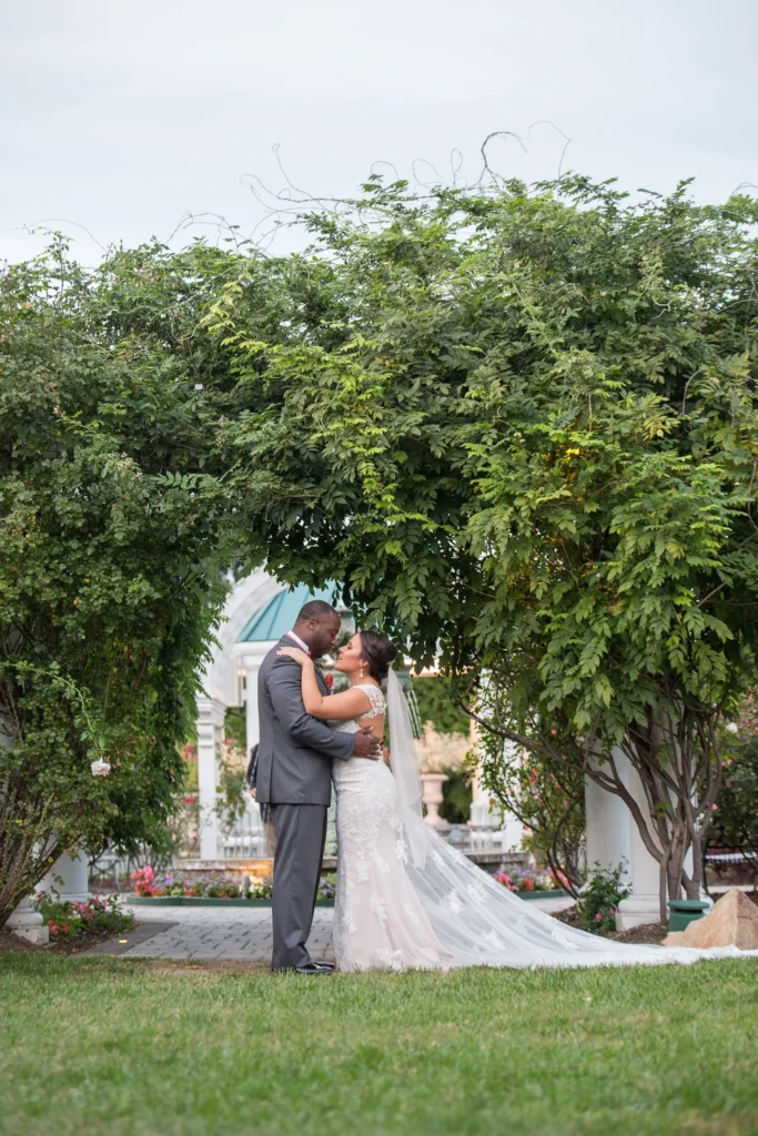 Couple embracing under a garden arbour