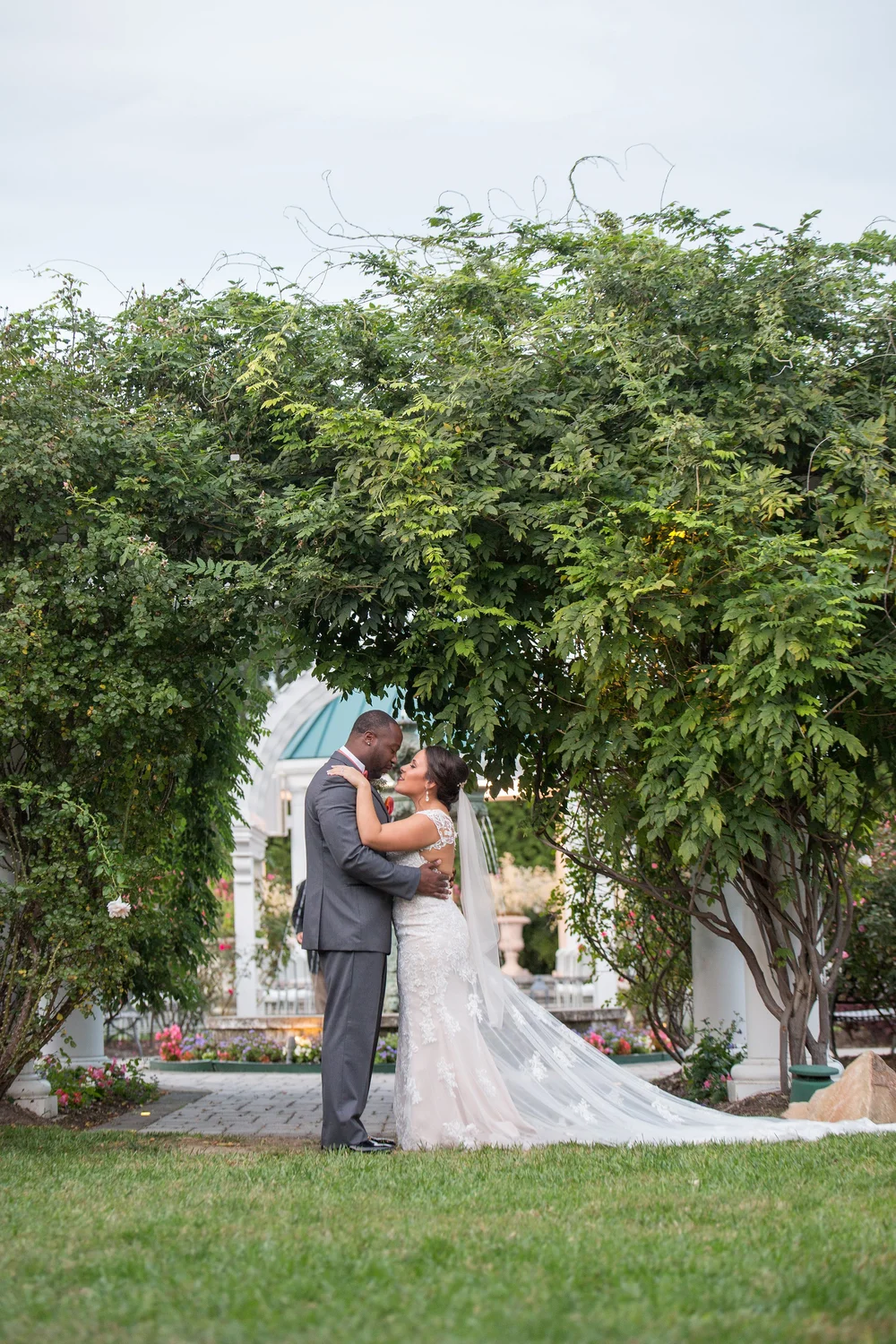 Couple embracing under a garden arbour