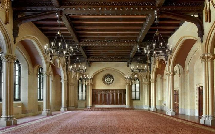 Grand historic ballroom with vaulted ceilings and chandeliers