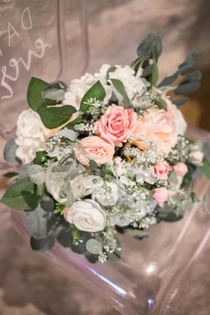 Blush and ivory bridal bouquet resting on a wooden surface