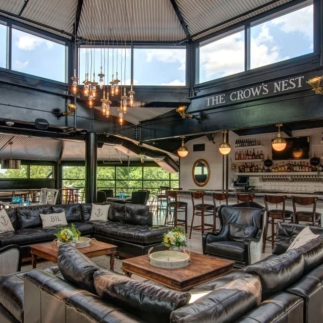The Crow's Nest rooftop bar with leather seating and harbour views