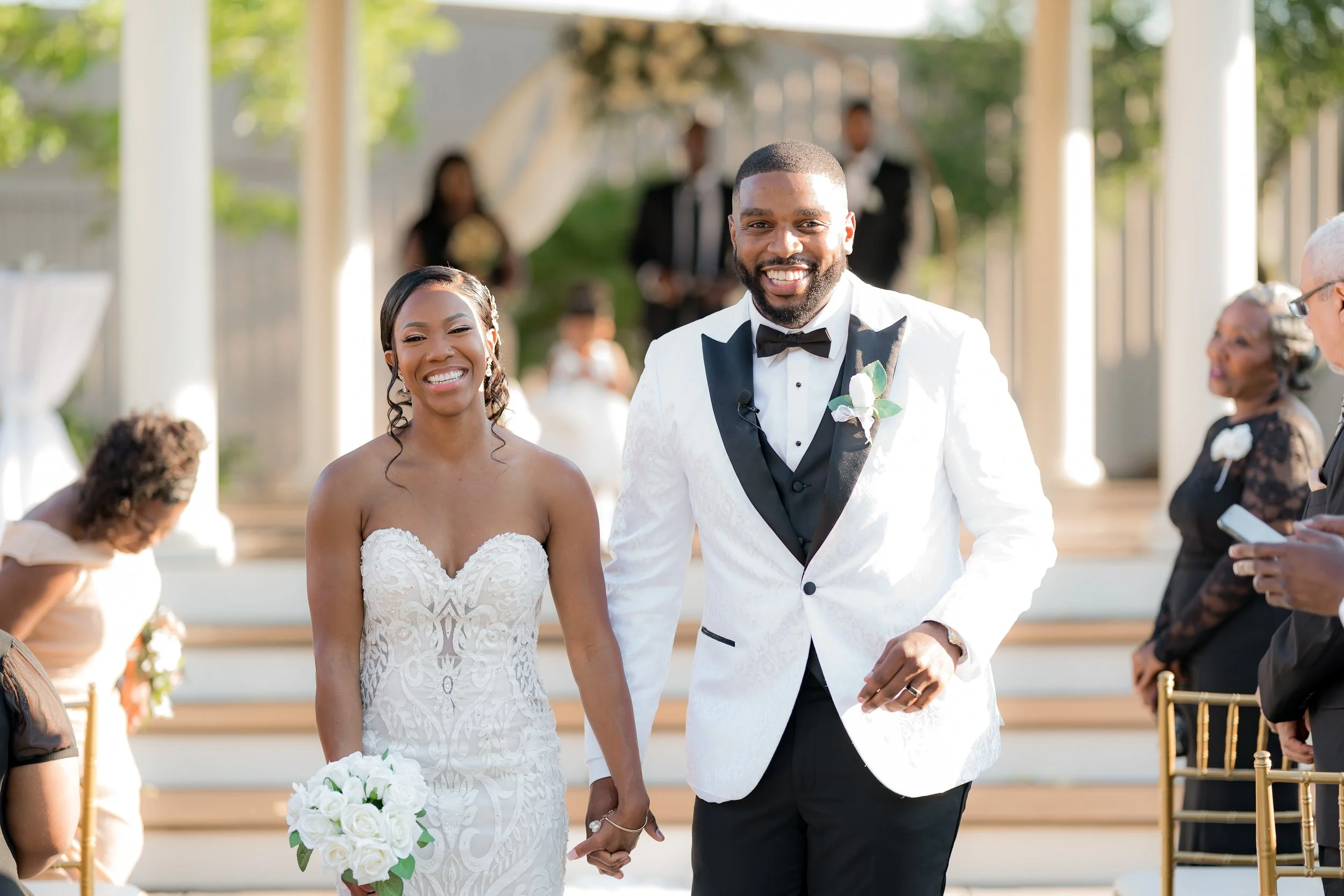 Bride and groom smiling together on the ceremony steps after the recessional