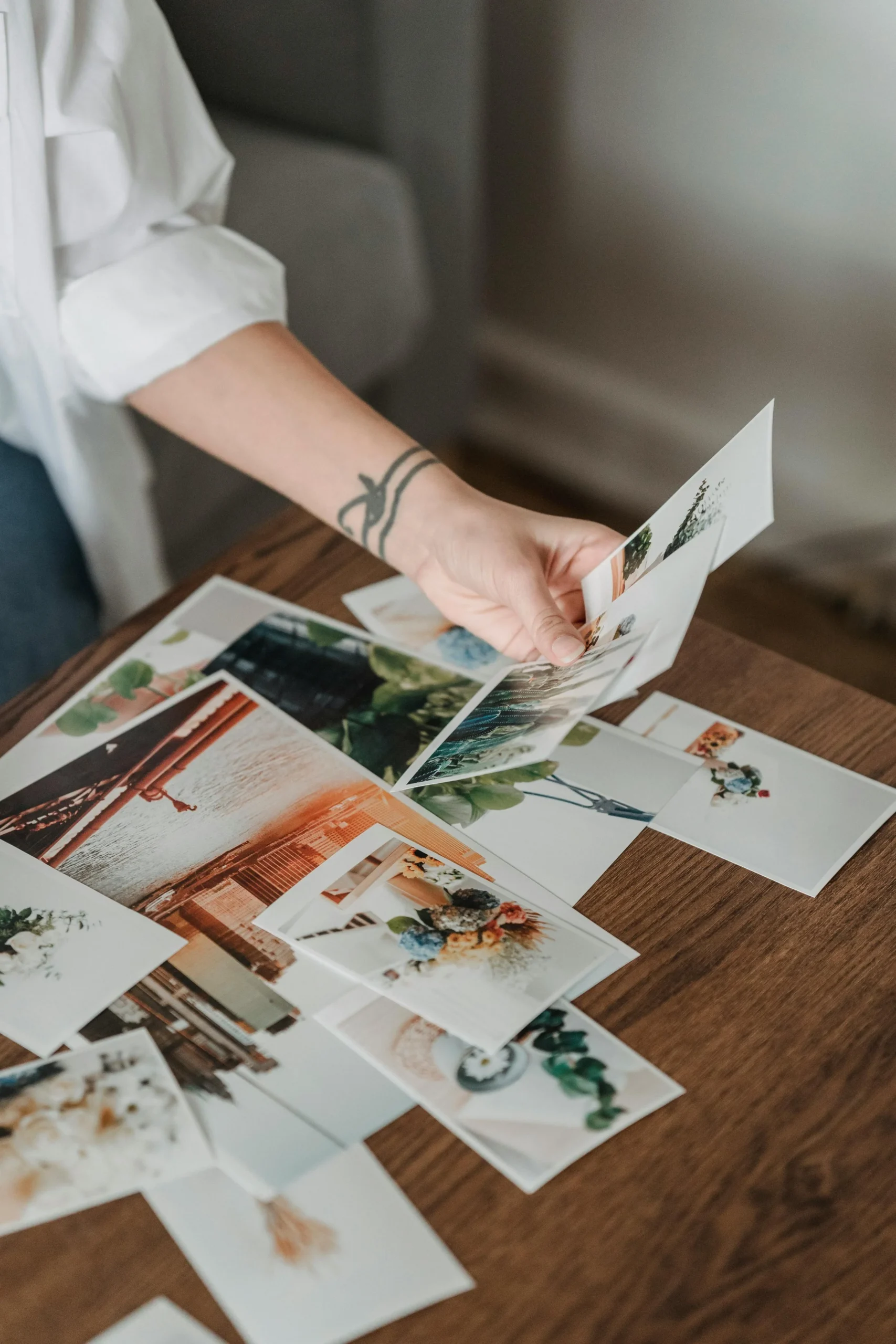 A bride and groom reviewing their wedding photos with a professional photographer, highlighting the collaborative process.