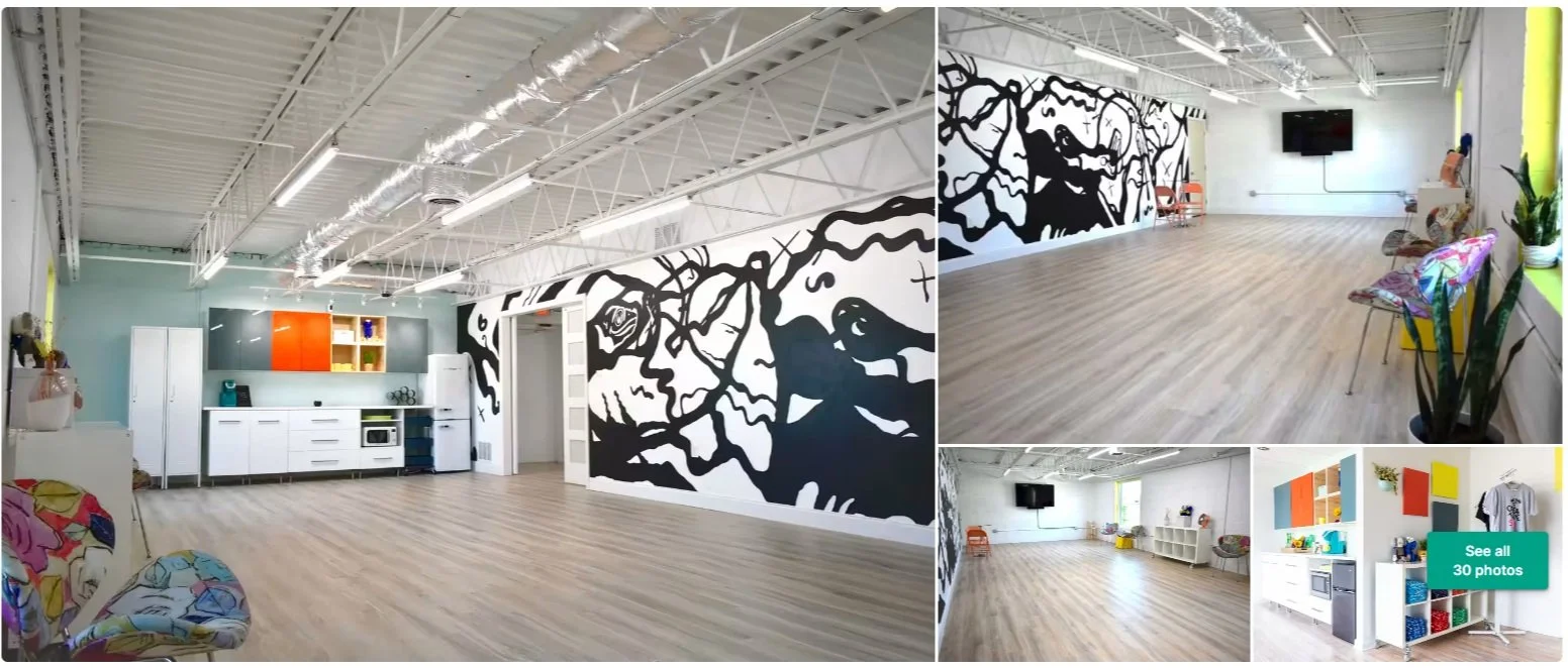 Modern white event space with a black line mural along one wall