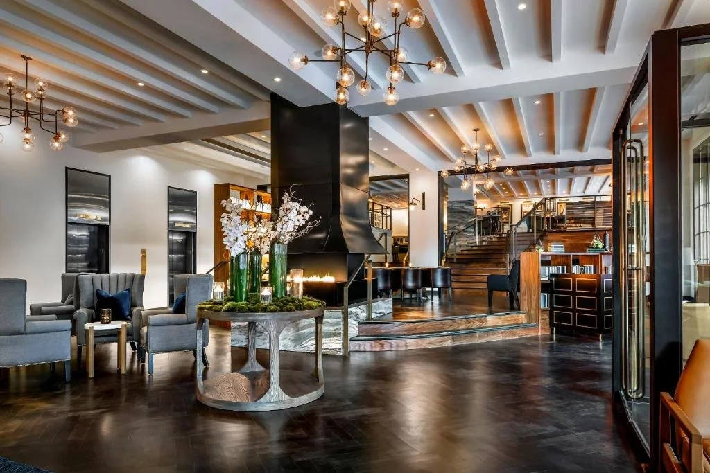 Hotel lobby lounge with sculptural lighting and a marble bar