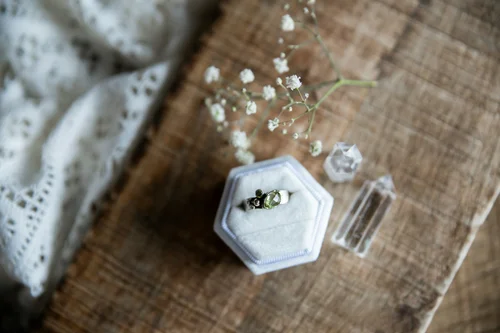 Wedding rings in a hexagonal glass ring box on lace
