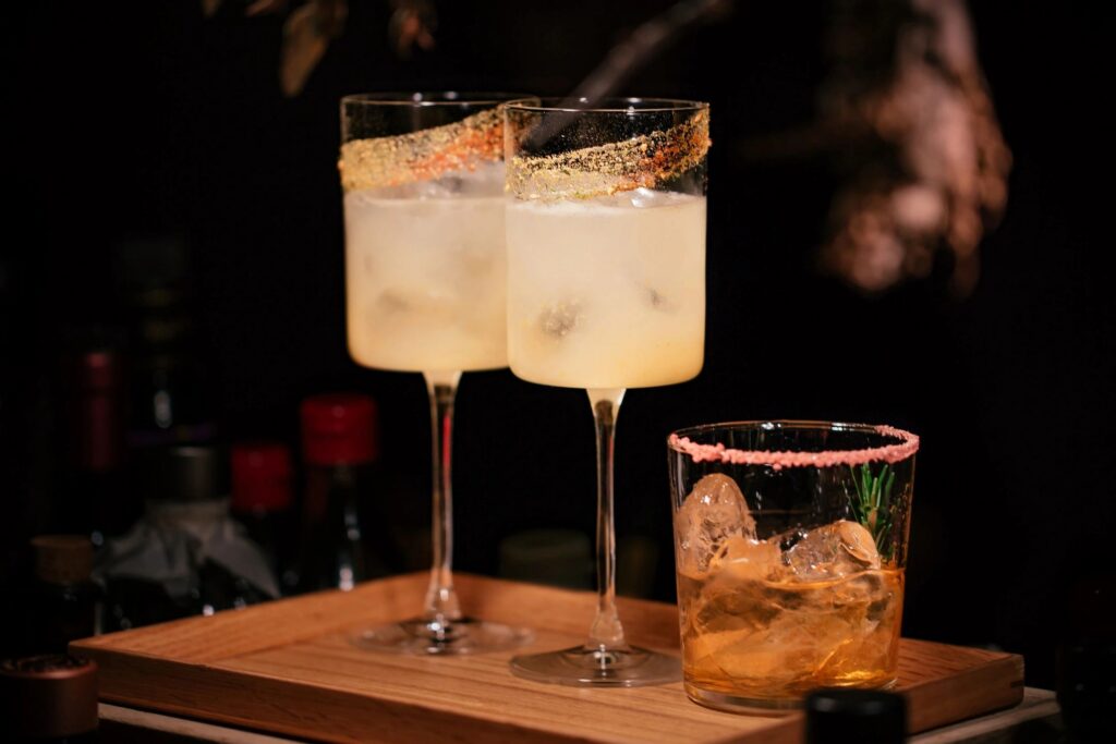 Fall cocktails with sugared rims on a serving board